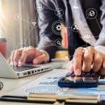 Businessman calculates financials with graph paper on the table