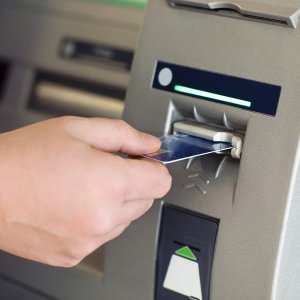 Putting a debit card into an ATM machine