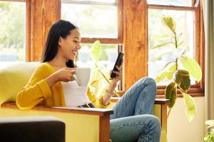 young woman on cell phone, relaxing at home